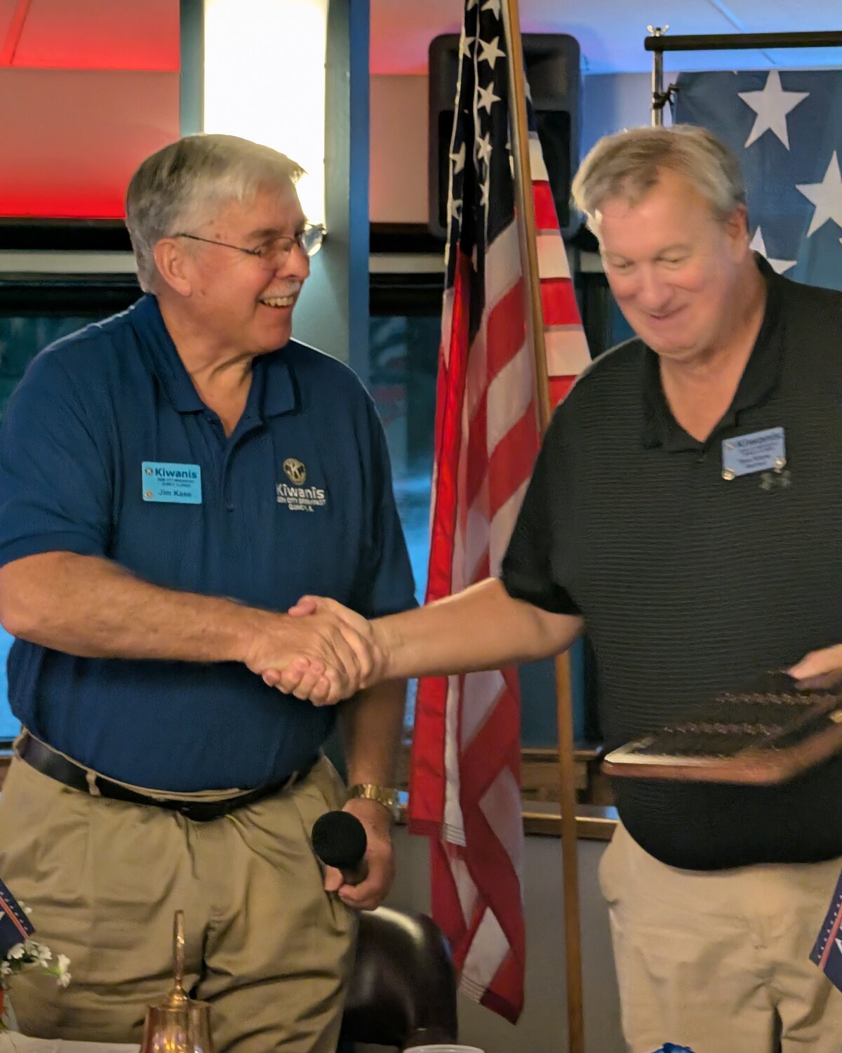 Incoming president Jim Kase and past president Tom Klene shaking hands